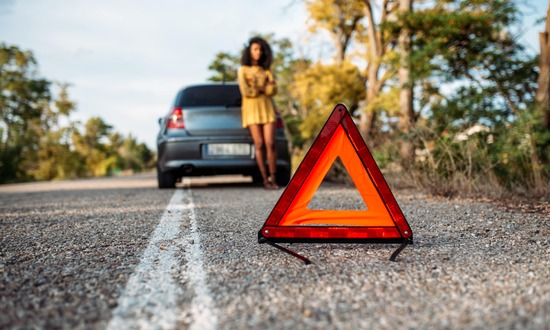 woman-with-broken-car-and-triangle-2RSGLN7-min.jpg